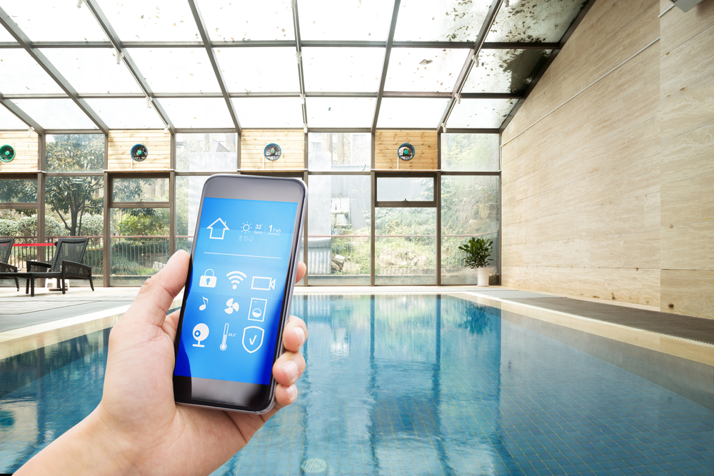 Smart,phone,with,smart,home,and,swimming,pool,in,modern