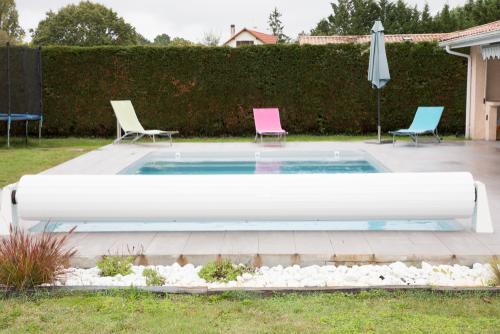 Rigid,cover,rolls,over,an,outdoor,swimming,pool